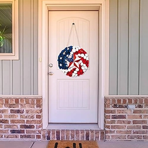 Patriotic July 4th door wreath with American flag stars and stripes hanging on a house door