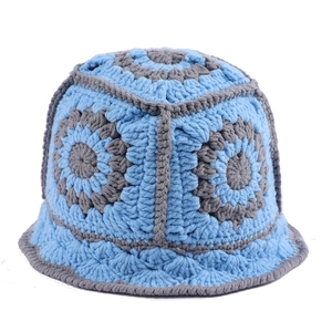 Close-up of handmade crochet bucket hat featuring blue and grey floral knit patterns