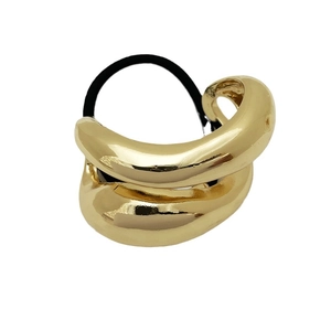 Minimalist gold geometric hair tie with irregular metal ring on black elastic band