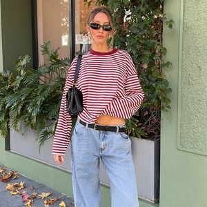 Detailed view of red and white striped long sleeve shirt with crew neck and casual fit