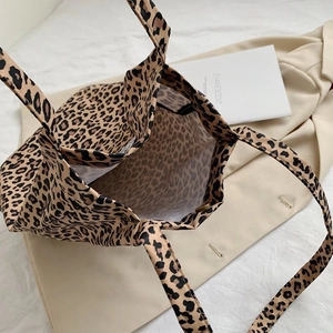 Top view of leopard print canvas tote bag featuring magnetic closure and soft fabric lining