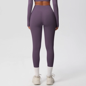 Detail view of the high-waist shaping waistband on dark purple fitness yoga leggings
