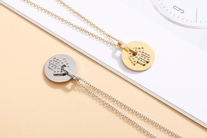 Detailed view of gold and silver Hamsa hand necklaces with sparkling crystals on O-chains