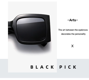 Close-up of black oversized square sunglasses with high-gloss finish and dark lenses