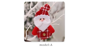 Detail of Christmas Santa hanging ornament in red plaid fabric on a snowy white branch