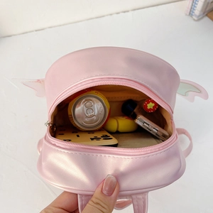 Pink PU leather children backpack with wing details showing the open main compartment storage