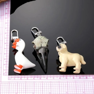 Detailed view of creative animal resin charms showing realistic textures and size scale
