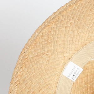 Flat top natural raffia straw sun hat with wide brim and fine woven texture for beach