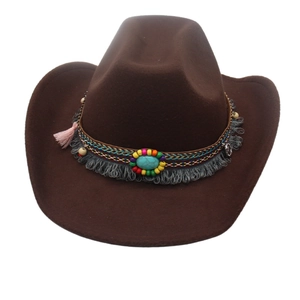 Close-up of brown cowboy hat with ethnic beaded band, turquoise stone, and pink tassels