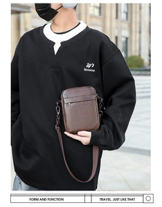 Close-up of vintage textured dark brown PU leather crossbody bag on male model outdoors