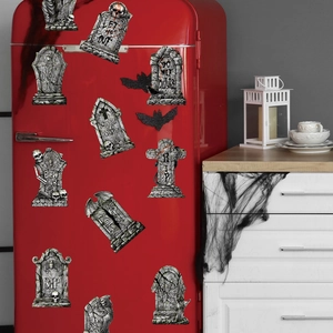 Halloween gravestone magnets with spooky text on a red vintage refrigerator door