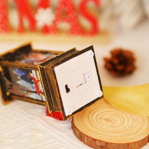Detail view of the vintage Christmas lantern bottom with battery compartment and power switch
