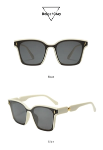 Detail view of square sunglasses with gold lightning accents and beige-black frame