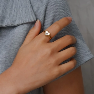 18K gold plated heart ring with white shell inlay and crystal shown on model hand