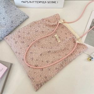 Detailed close-up of pink floral tote bag with lace overlay and pearl embellishments