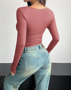 Back view of a slim fit reddish-brown square neck long sleeve top with denim jeans