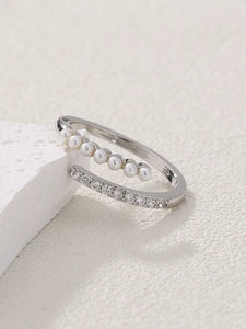 Detail of silver open ring with parallel rows of micro-pave pearls and zircon stones
