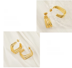 Detail of 18K gold plated stainless steel hoop earrings with triple-ring design and polished finish