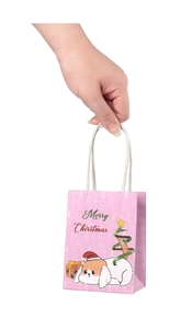 Pink Christmas gift bag with festive illustrations held by hand to show compact size