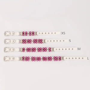 Detailed view of white leather pet collars in sizes XS to L with pink pearls and studs