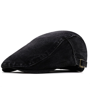 Detailed close-up of side copper buckle on washed denim flat cap with vintage texture