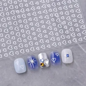 Hollow heart nail art stickers with silver and white aesthetic starburst accents