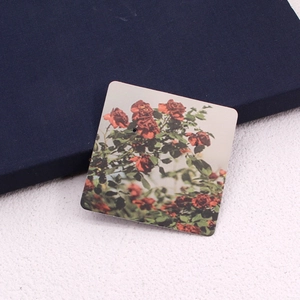 Detailed view of square jewelry card with vintage red rose floral print for earrings