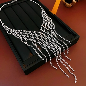 Detail of silver-tone tassel necklace with sparkling crystals in a black gift box