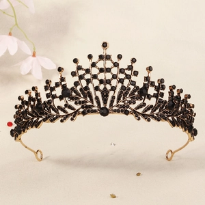 Detailed view of vintage gold bridal crown with intricate black gemstone embellishments