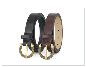Detailed view of black and brown leather belts with gold twisted metal buckles