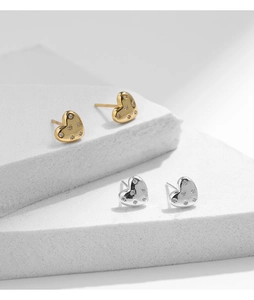 Detailed view of S925 sterling silver heart earrings in gold and silver finish with zircons