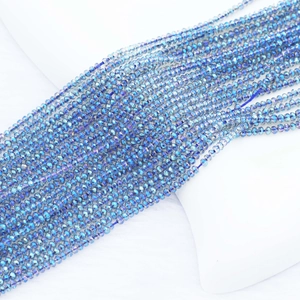 Macro shot of 2mm faceted crystal beads with iridescent blue electroplated finish