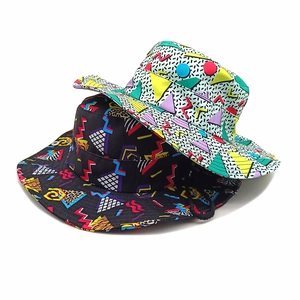 Detail of Memphis style canvas bucket hats with adjustable chin straps in black and white