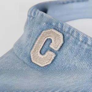 Close-up of vintage light blue washed denim cap with letter C embroidery detail