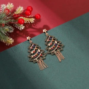 Detailed close-up of Christmas tree earrings with colorful rhinestones and gold tassels