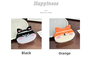 Detail showing cute Corgi hair clips in black and orange glossy resin finish