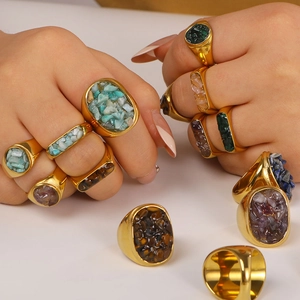 Gold stainless steel rings set with natural stones shown on model hand and flat lay