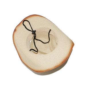 Detail of straw cowboy hat interior showing the sweatband and adjustable chin strap