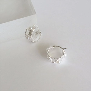 Minimalist S925 sterling silver hoop earrings with white pearls on a white background