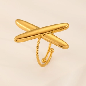 Close-up of golden adjustable ring with a large cross design and twisted rope band