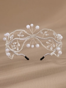 Macro view of handcrafted bridal headband with silver beads and crystals on velvet