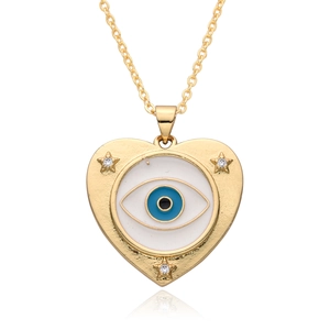 Gold evil eye heart necklace with blue enamel and star accents on white background