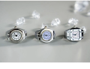 Detailed view of silver alloy ring watches in round, square, and tonneau shapes