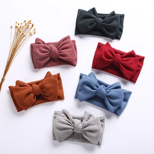 Detailed waffle knit texture and vibrant colors of handmade baby bow headbands