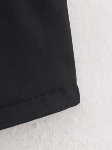 Macro shot of high-quality black twill fabric stitching and sewing detail on sleeveless jacket