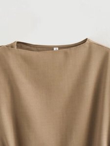 Detailed view of brown crewneck top collar area with size S label and fabric texture