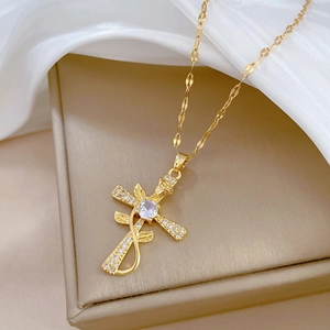 Detailed close-up of a gold-plated cross pendant with rose vine and sparkling zircons