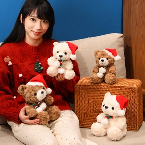 Christmas teddy bear plush toy with red hat and striped scarf in cozy holiday setting