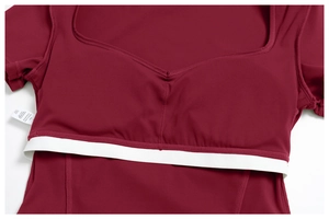Detailed close-up of dark wine red yoga top featuring built-in elastic support band