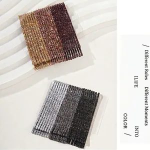 Set of 24 gradient glitter bobby pins in gold and silver tones on white display